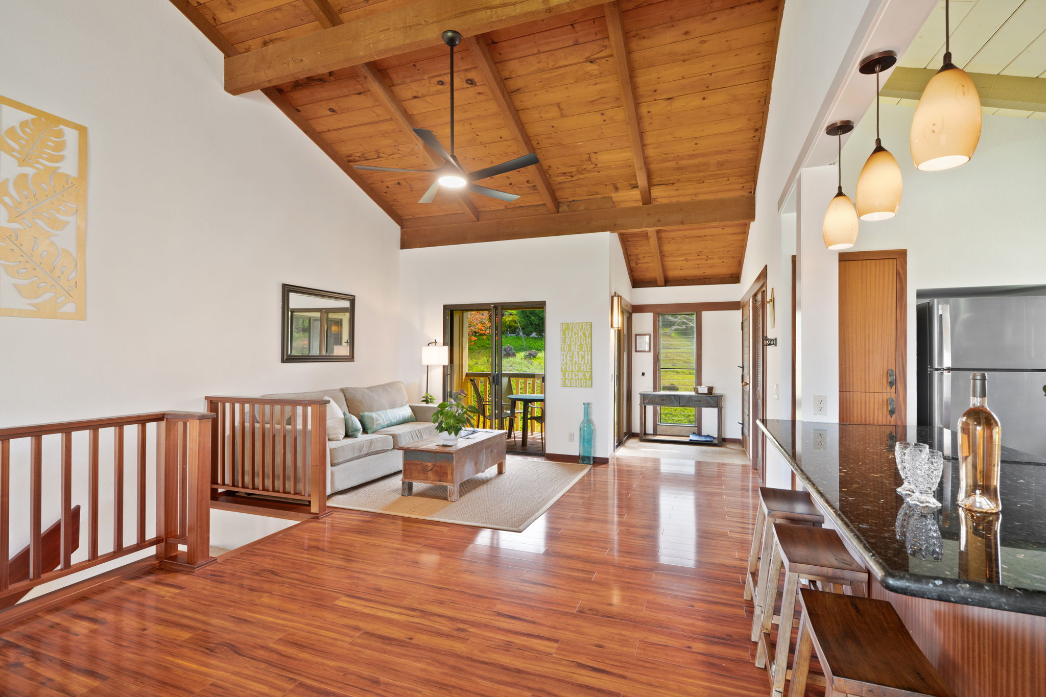 1870 Hoone Road, Unit 600 Koloa, HI 96756 - Photo 10 of 30 a living room with furniture floor to ceiling window and wooden floor