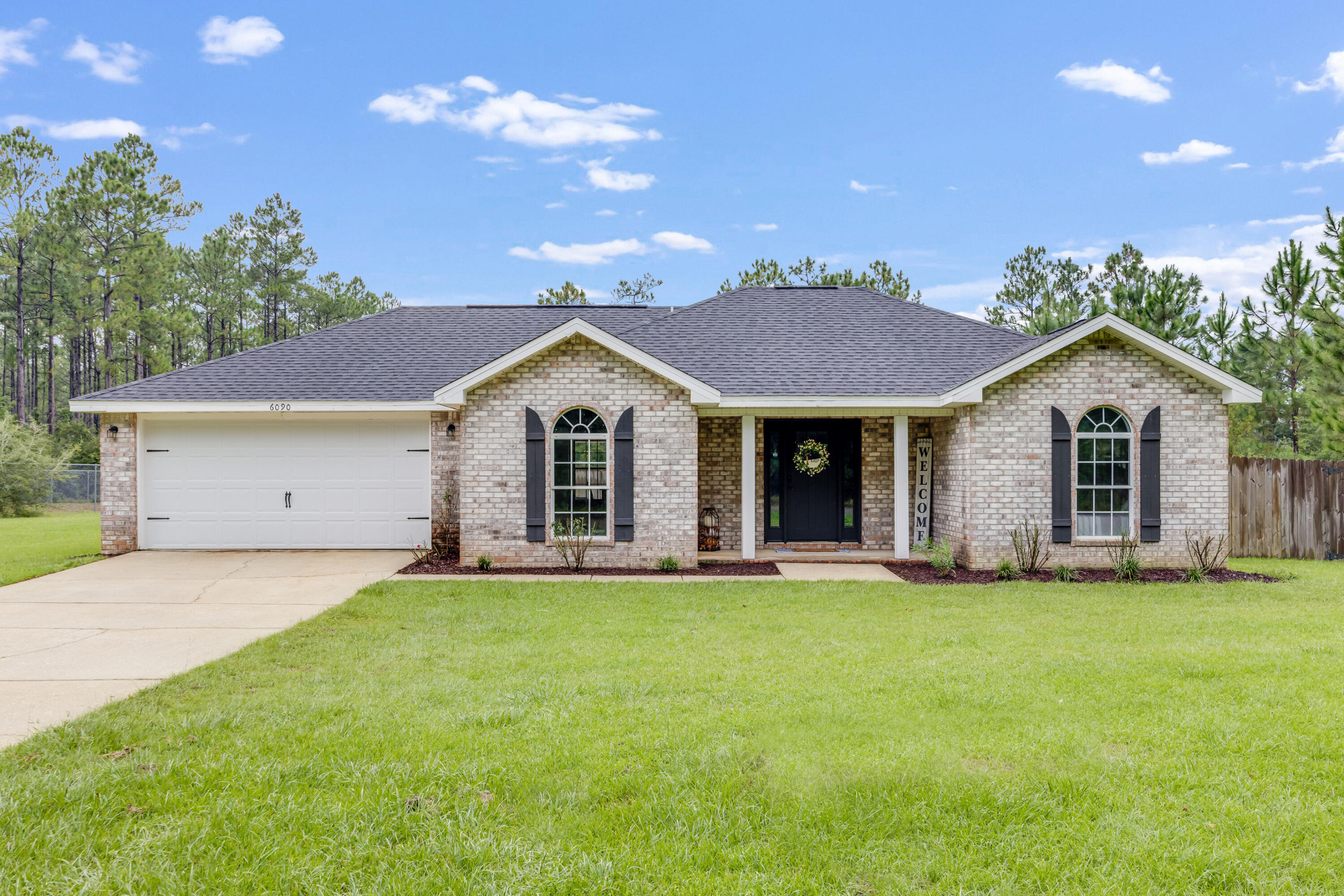 6090 Buckward Road Baker, FL 32531 - Photo 1 of 51 a front view of a house with a yard