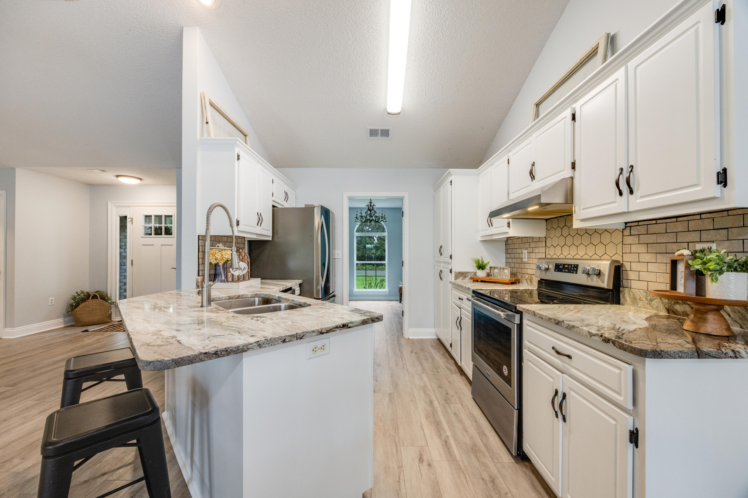 6090 Buckward Road Baker, FL 32531 - Photo 13 of 51 a kitchen with stainless steel appliances granite countertop a sink stove cabinets and refrigerator
