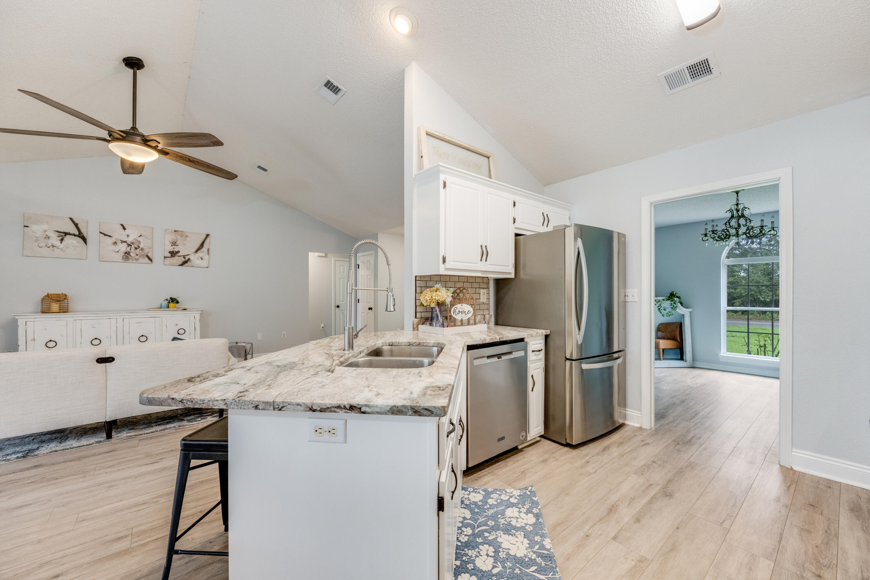 6090 Buckward Road Baker, FL 32531 - Photo 14 of 51 a kitchen with granite countertop cabinets stainless steel appliances and wooden floor