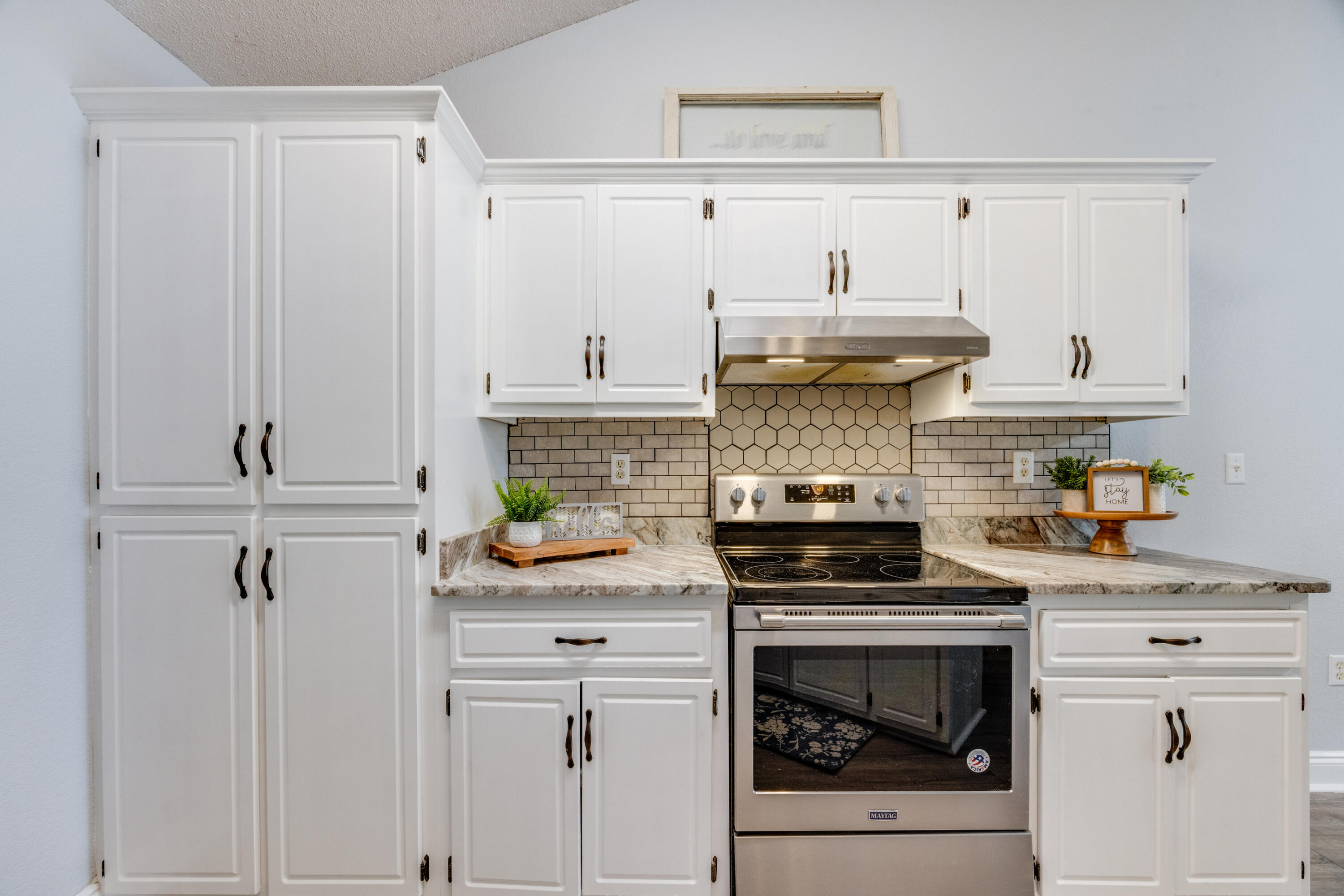 6090 Buckward Road Baker, FL 32531 - Photo 16 of 51 a kitchen with stainless steel appliances a stove and cabinets