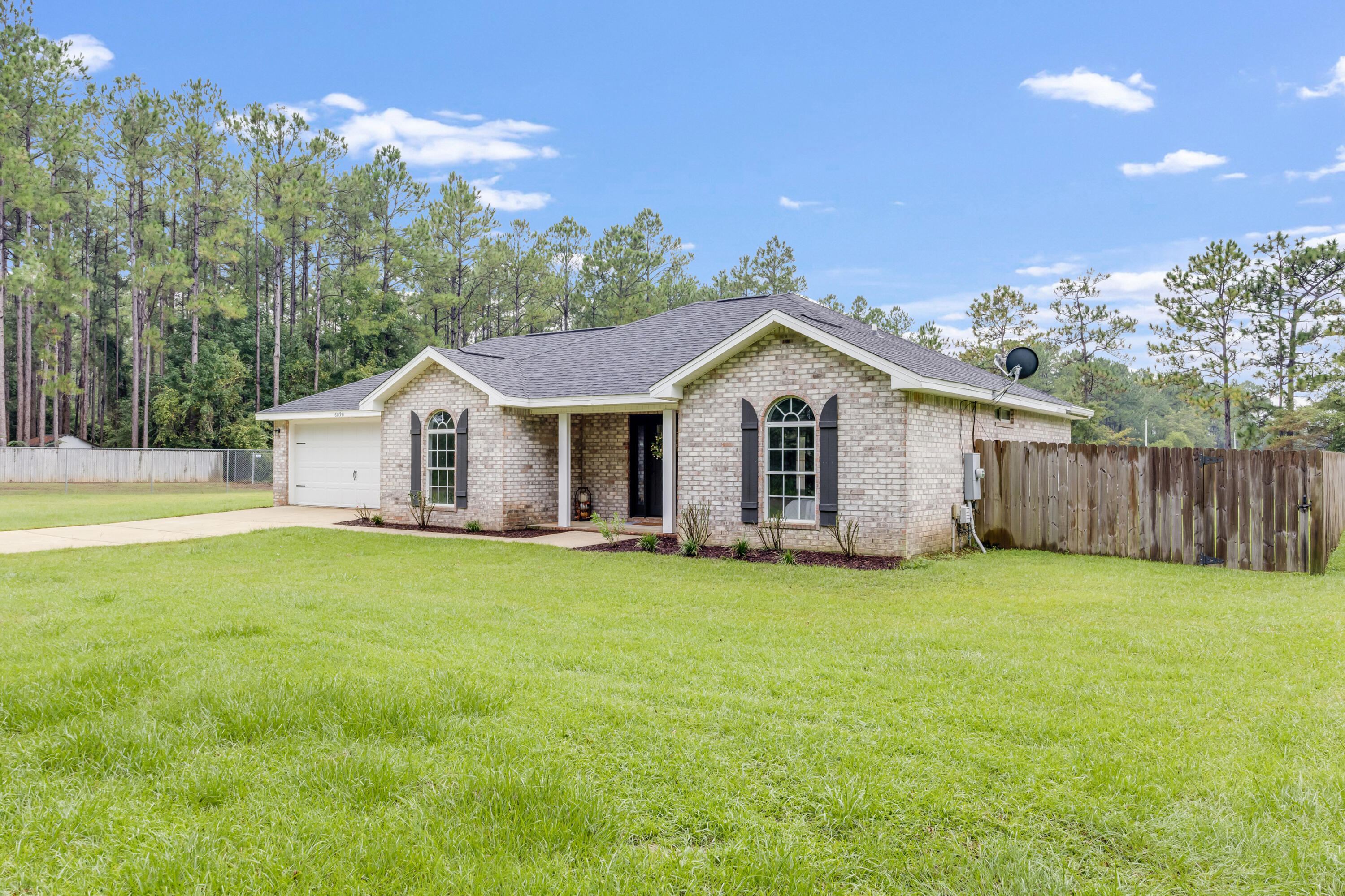 6090 Buckward Road Baker, FL 32531 - Photo 2 of 51 a view of a house with a yard and garage