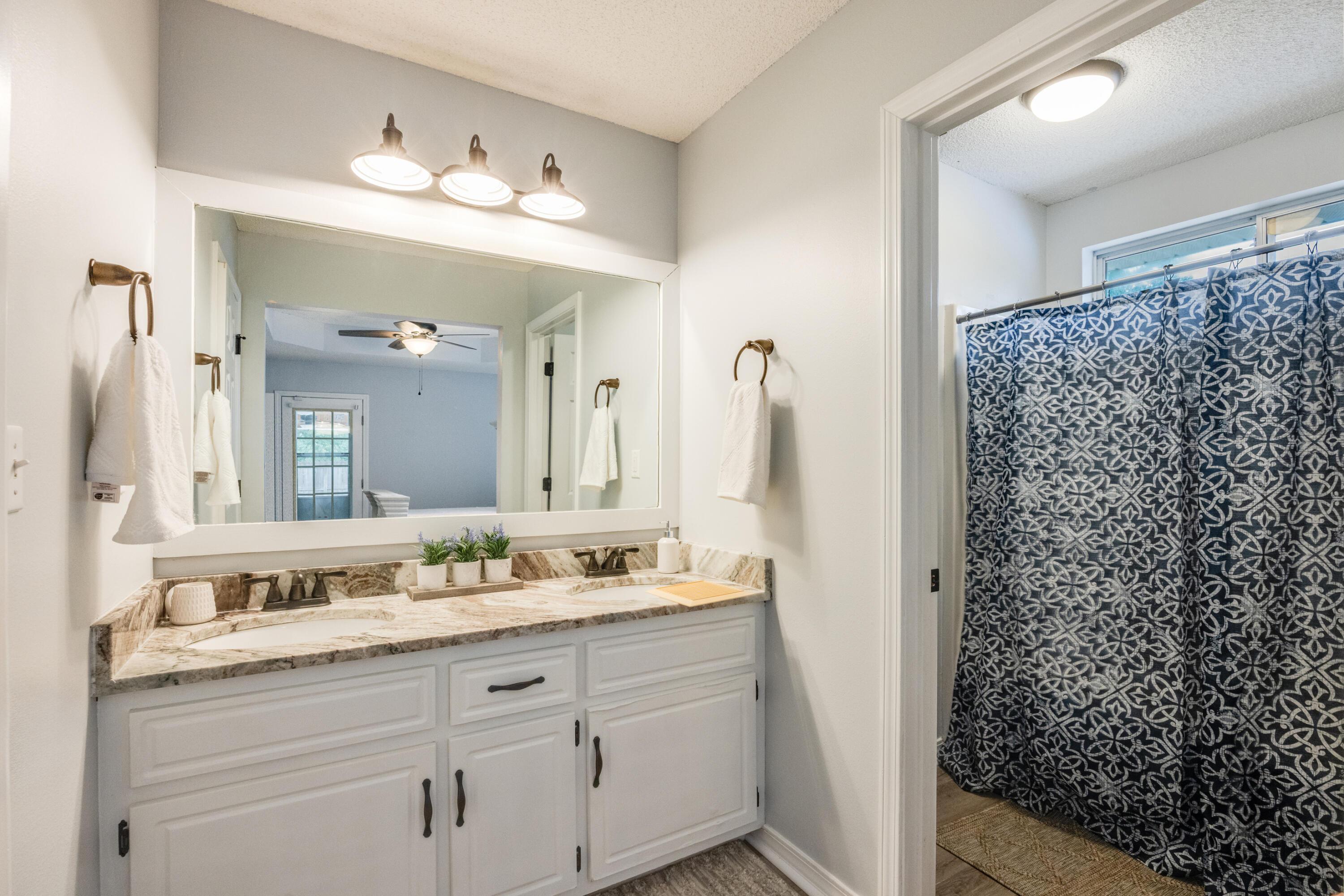 6090 Buckward Road Baker, FL 32531 - Photo 23 of 51 a bathroom with a double vanity sink mirror and shower