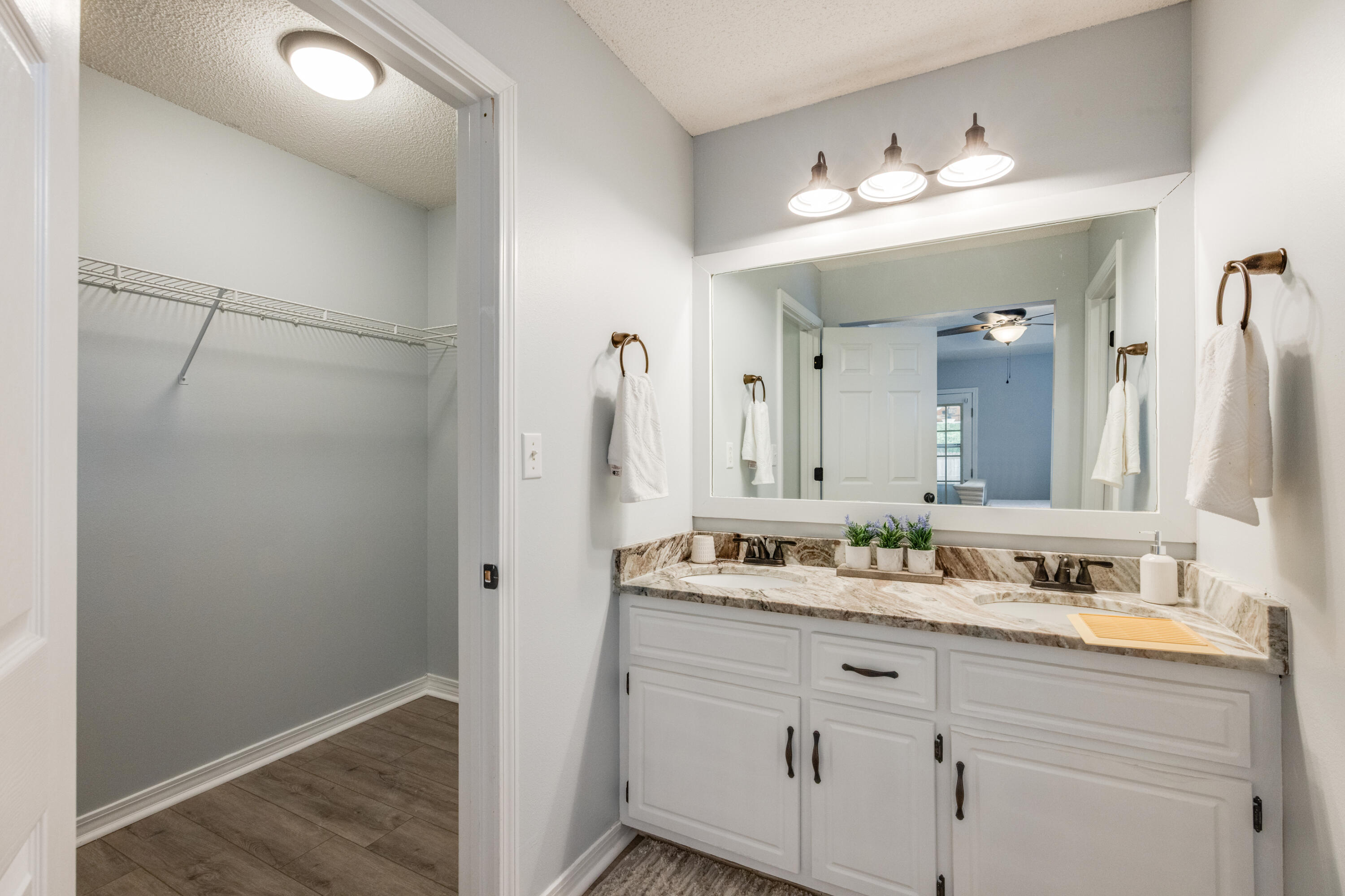 6090 Buckward Road Baker, FL 32531 - Photo 24 of 51 a bathroom with a double vanity sink and a mirror