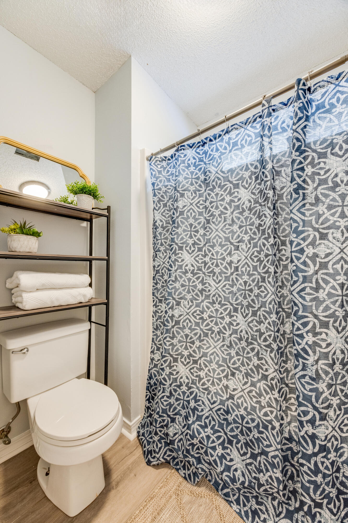 6090 Buckward Road Baker, FL 32531 - Photo 25 of 51 a bathroom with a toilet and a shower curtain