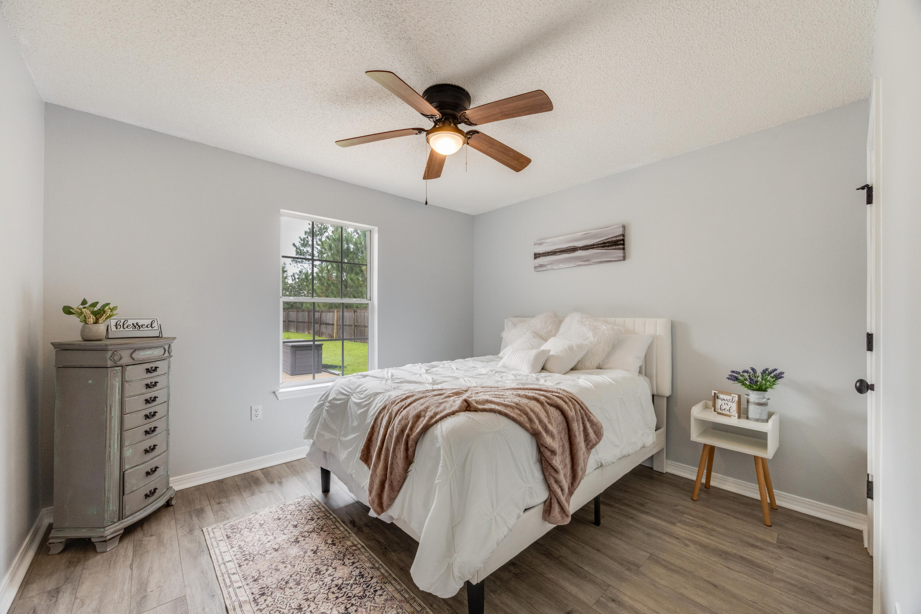 6090 Buckward Road Baker, FL 32531 - Photo 28 of 51 a bedroom with a bed and wooden floor