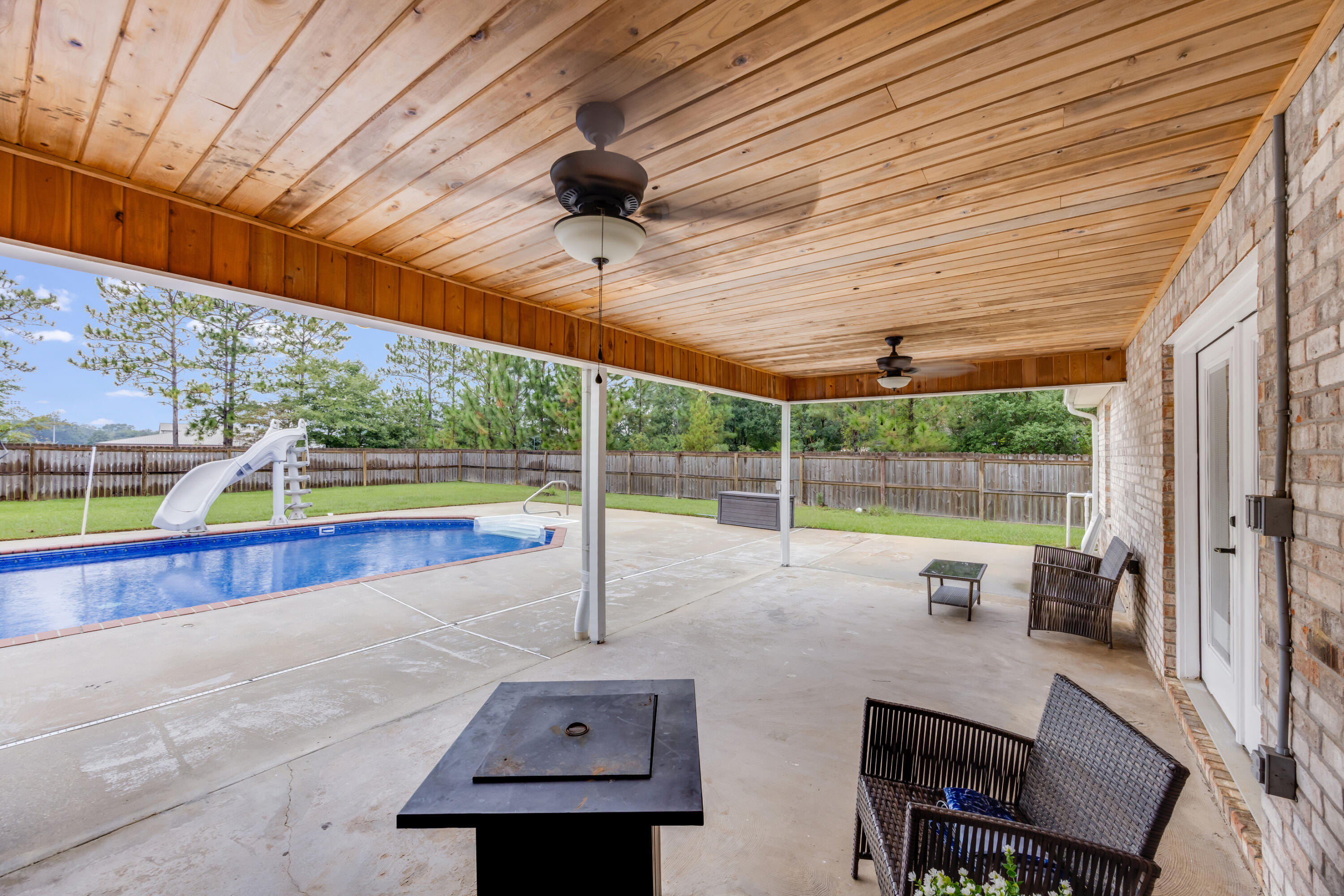 6090 Buckward Road Baker, FL 32531 - Photo 34 of 51 a view of a patio with a table and chairs