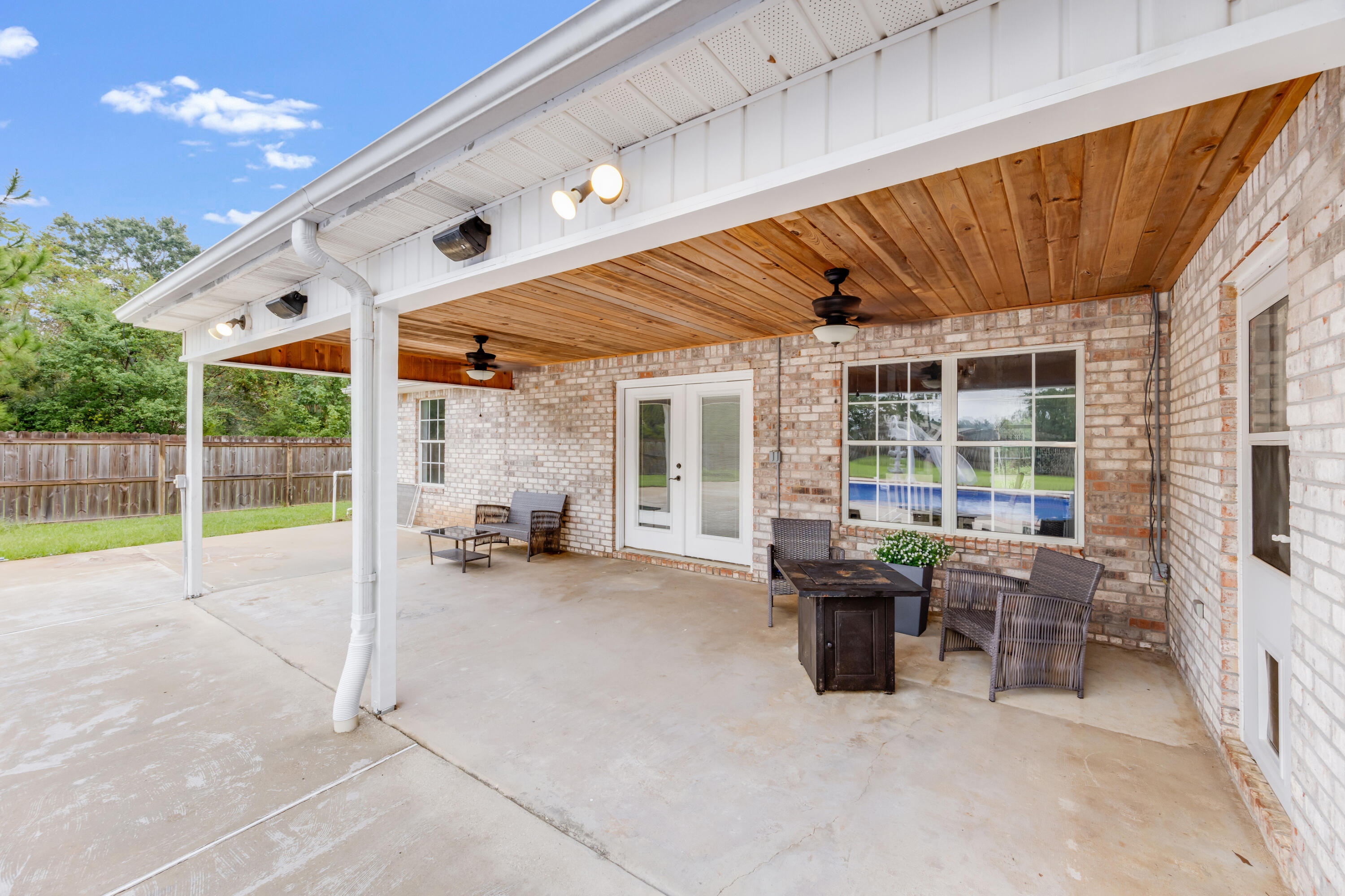 6090 Buckward Road Baker, FL 32531 - Photo 36 of 51 a view of a patio with a table and chairs and potted plants