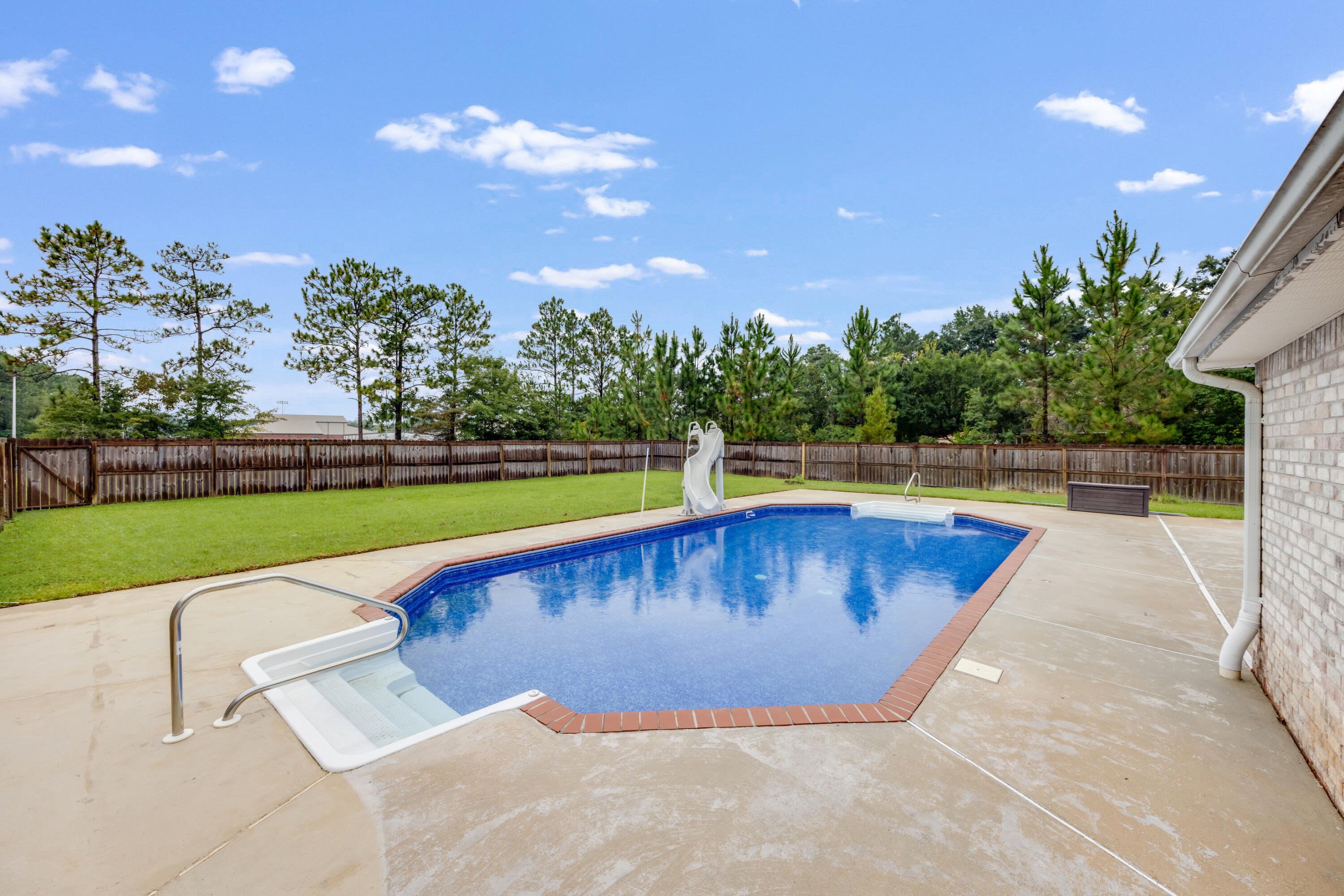 6090 Buckward Road Baker, FL 32531 - Photo 40 of 51 a view of a swimming pool with a yard and plants