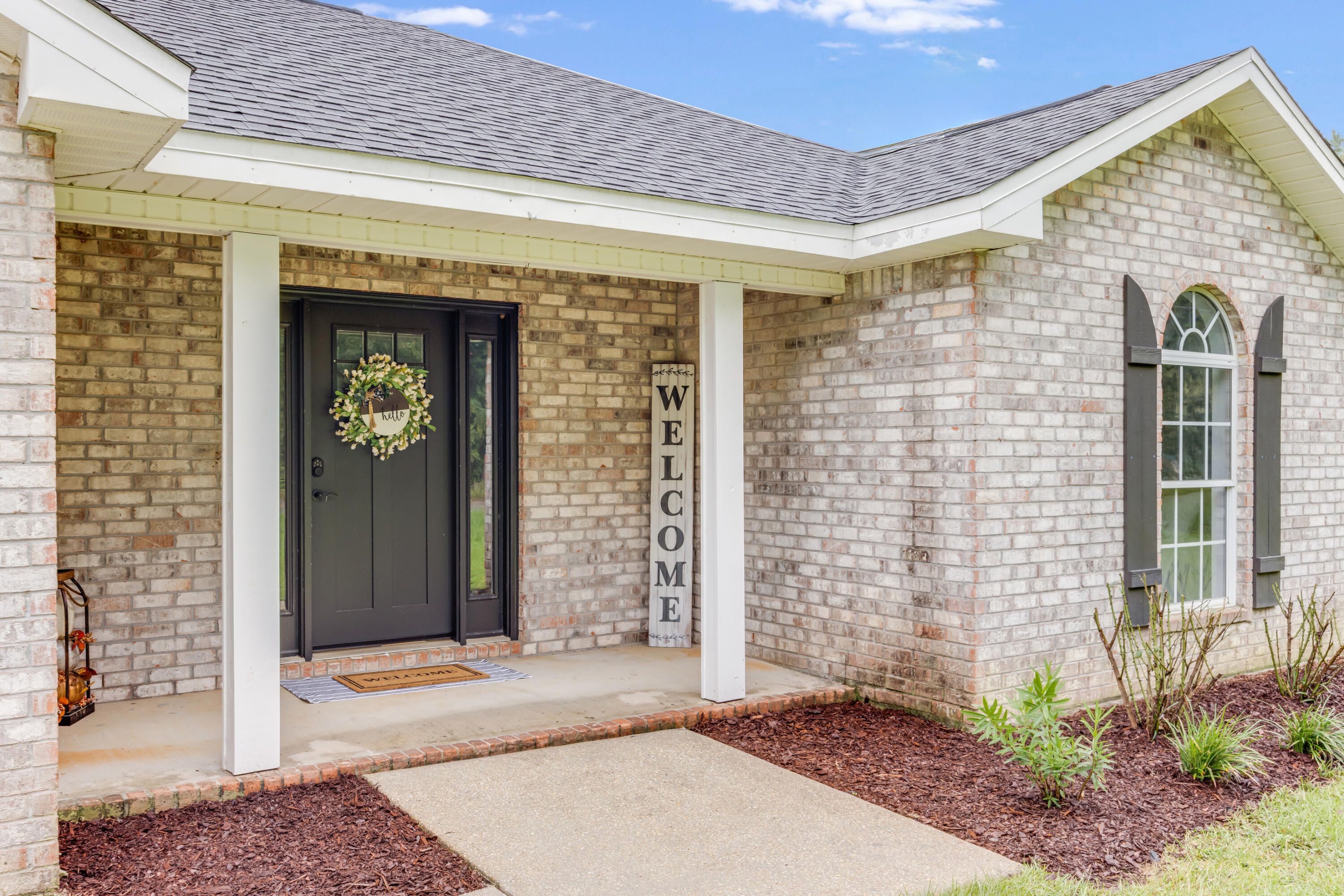 6090 Buckward Road Baker, FL 32531 - Photo 4 of 51 a view of a brick house with front door