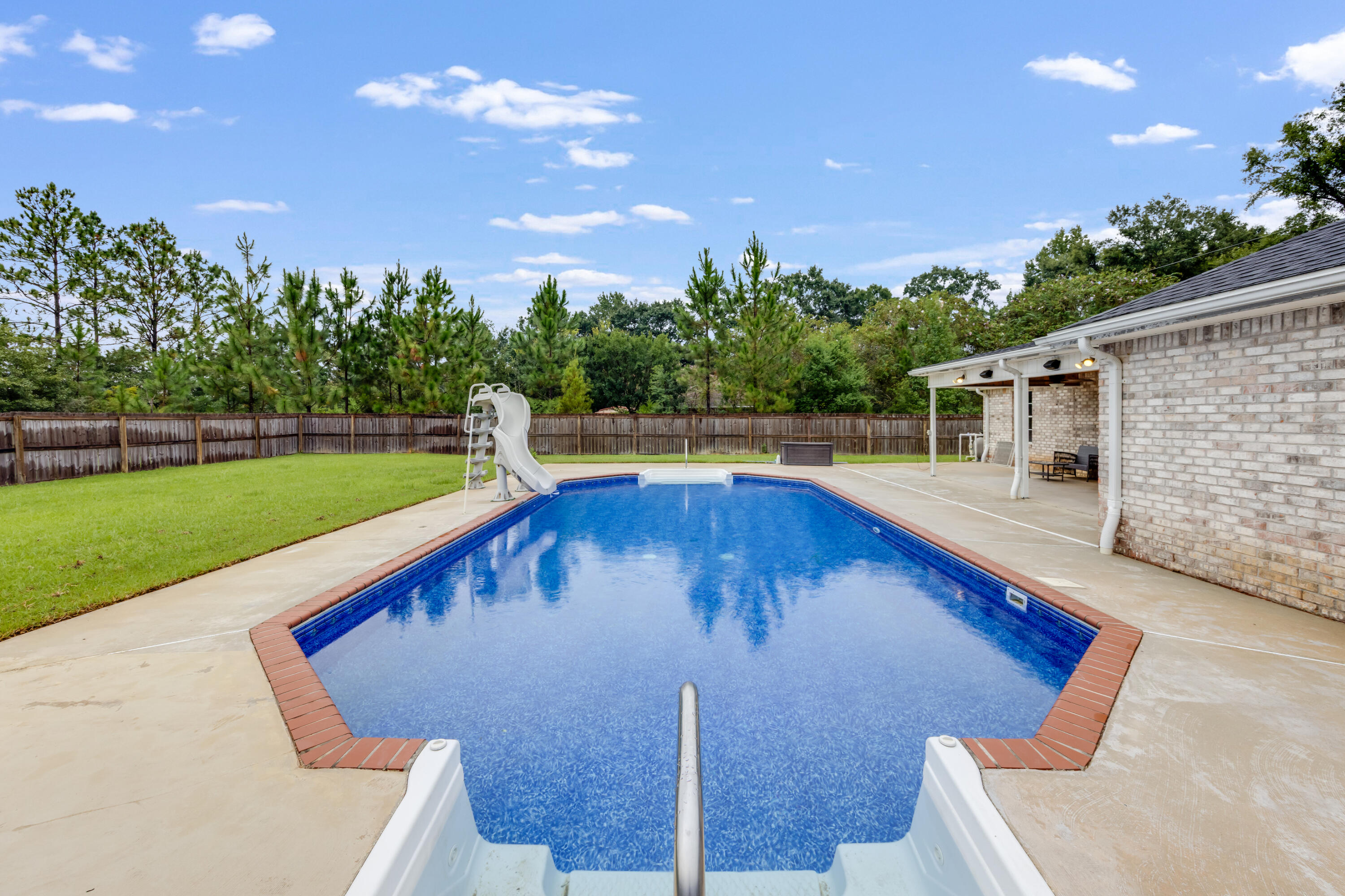 6090 Buckward Road Baker, FL 32531 - Photo 41 of 51 a view of a backyard with swimming pool