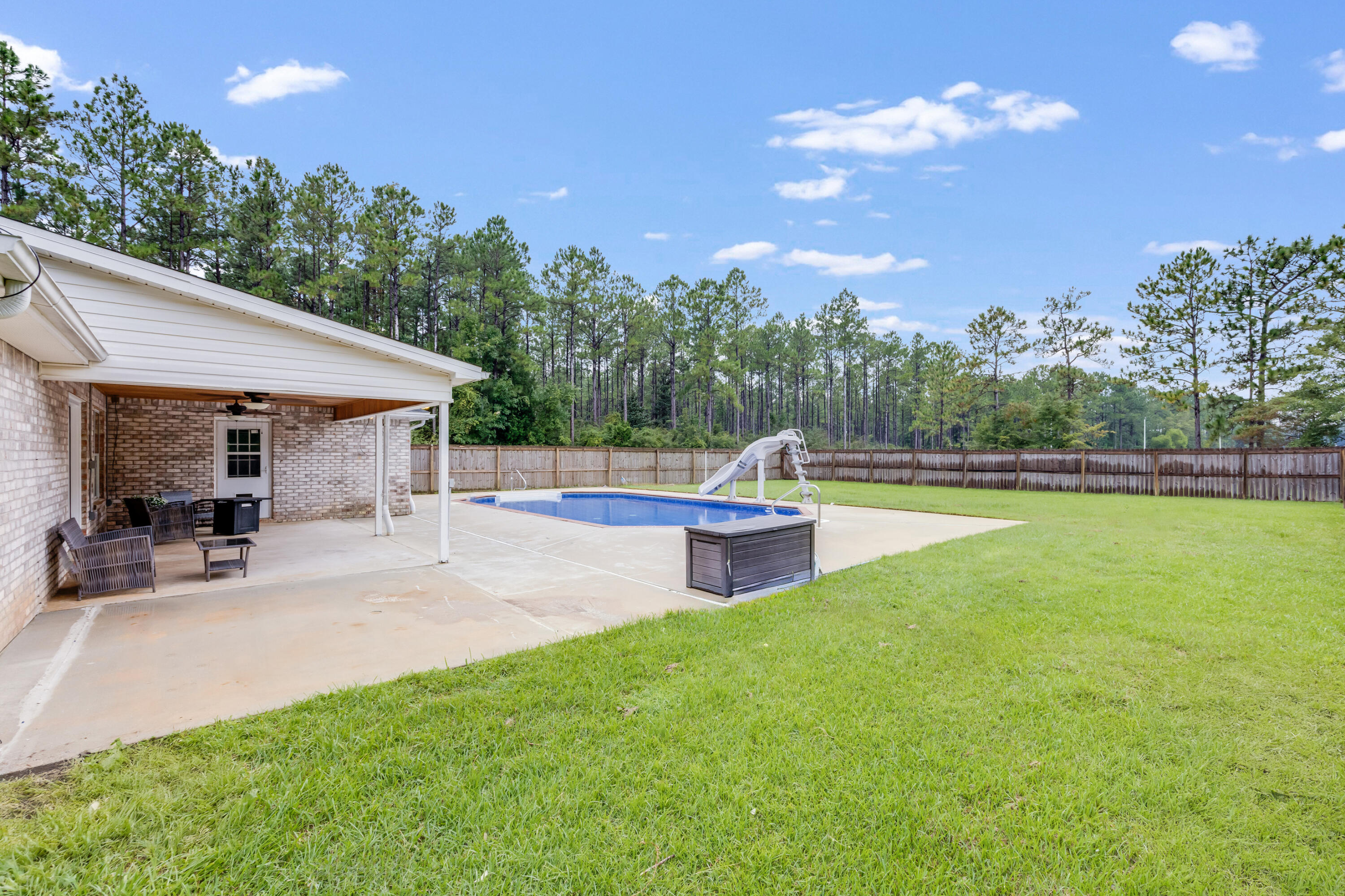 6090 Buckward Road Baker, FL 32531 - Photo 42 of 51 a view of a house with backyard porch and sitting area
