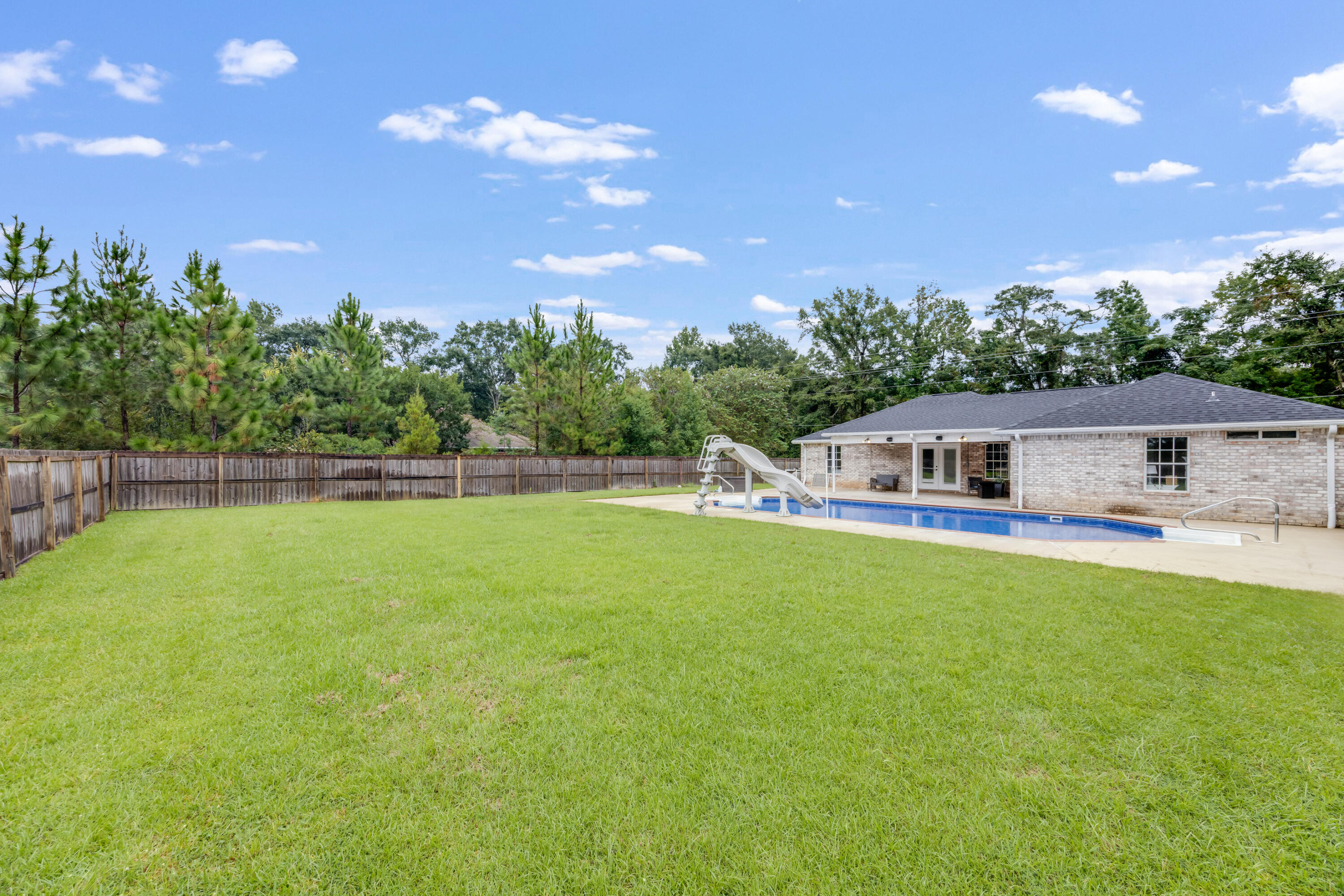 6090 Buckward Road Baker, FL 32531 - Photo 43 of 51 a front view of a house with a garden