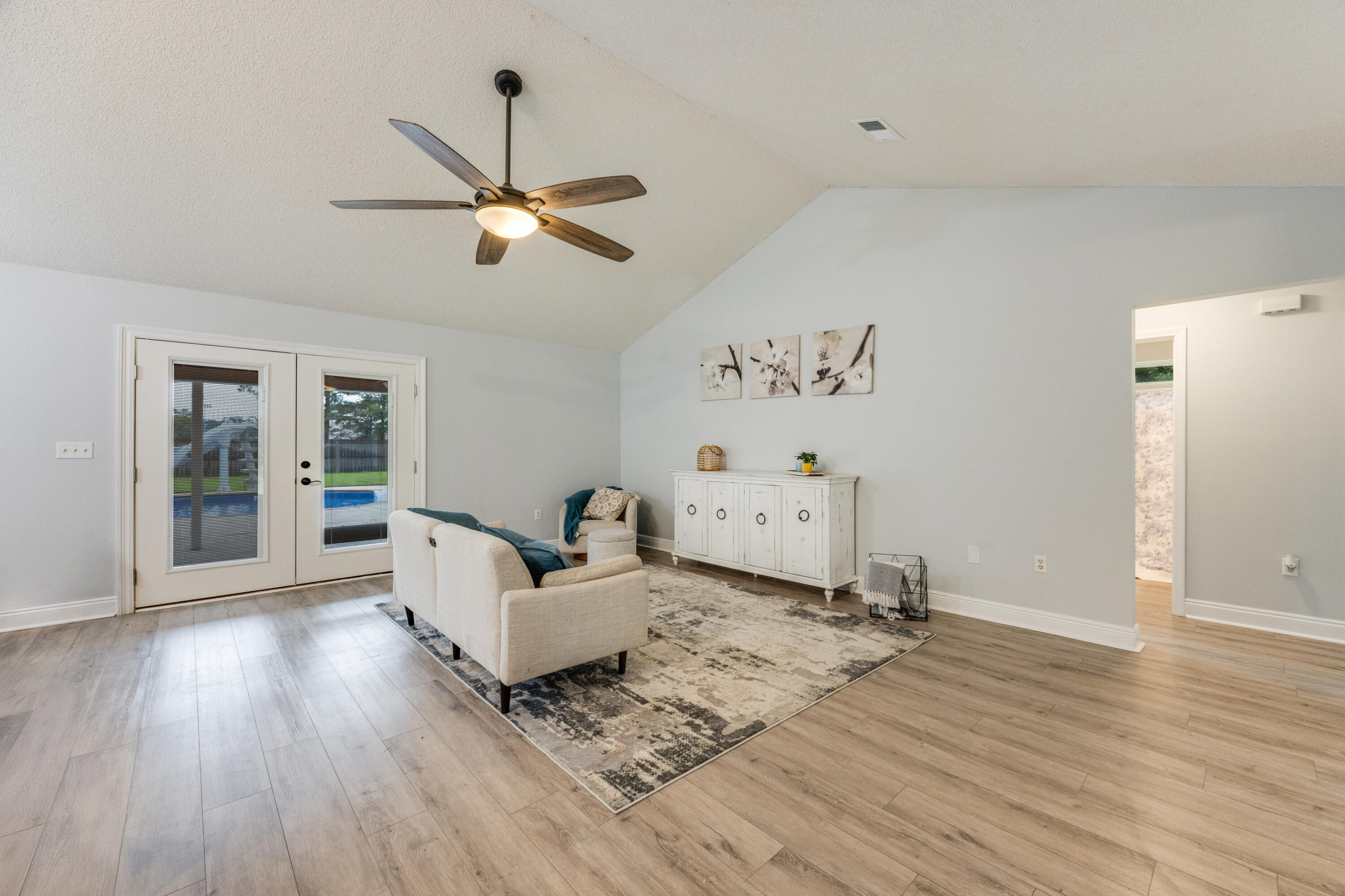 6090 Buckward Road Baker, FL 32531 - Photo 7 of 51 a living room with hard wood floors and a ceiling fan
