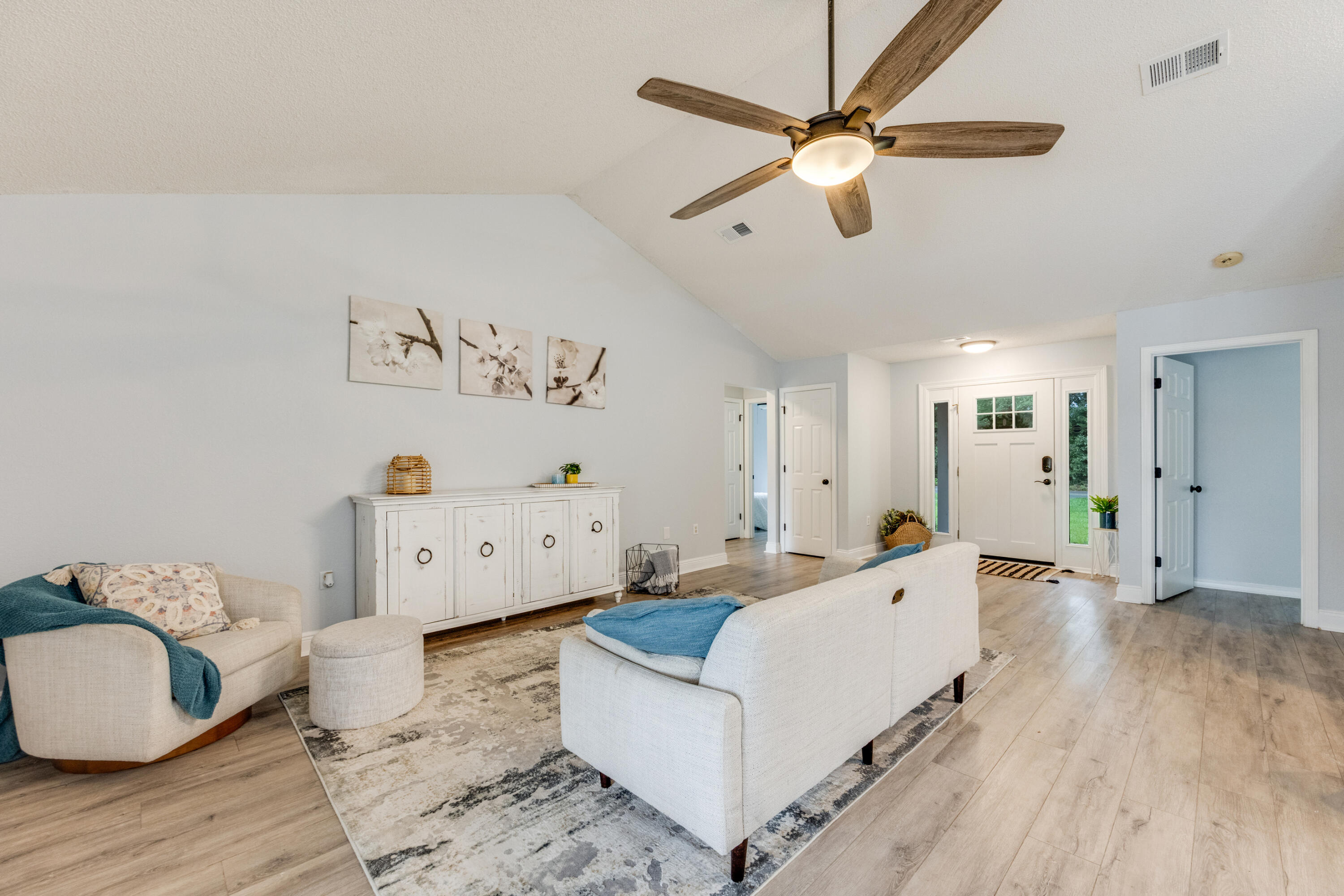6090 Buckward Road Baker, FL 32531 - Photo 8 of 51 a living room with furniture and a wooden floor