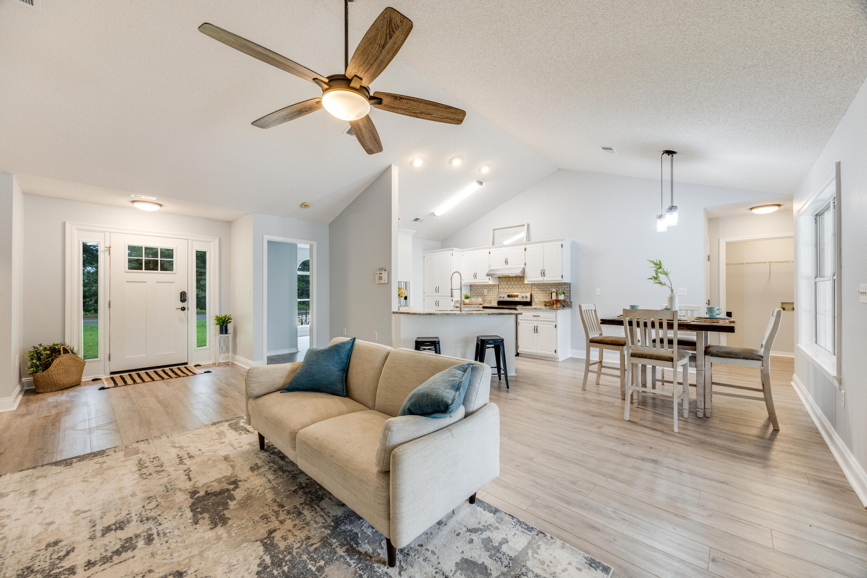 6090 Buckward Road Baker, FL 32531 - Photo 9 of 51 a living room with furniture kitchen view and a wooden floor