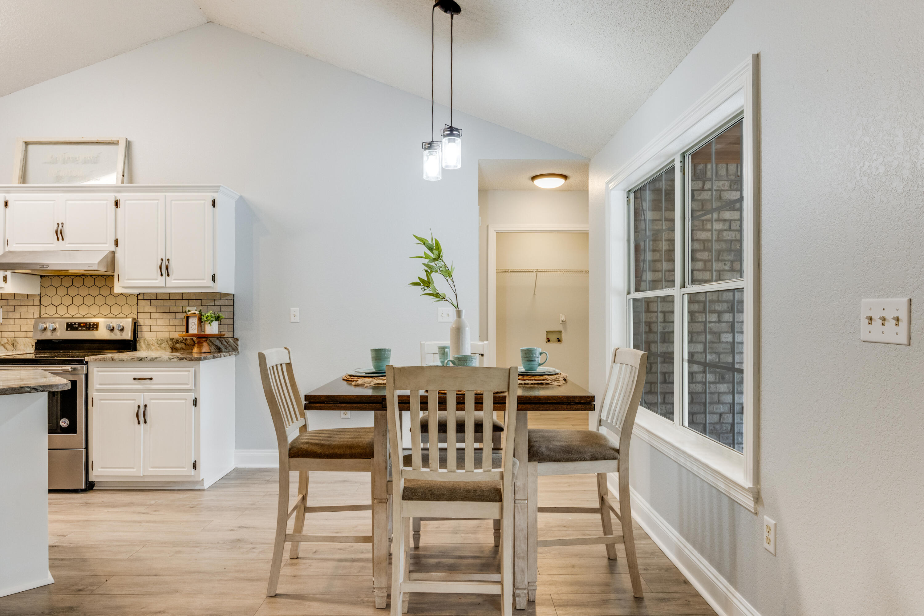6090 Buckward Road Baker, FL 32531 - Photo 10 of 51 a dining room with furniture a chandelier and wooden floor