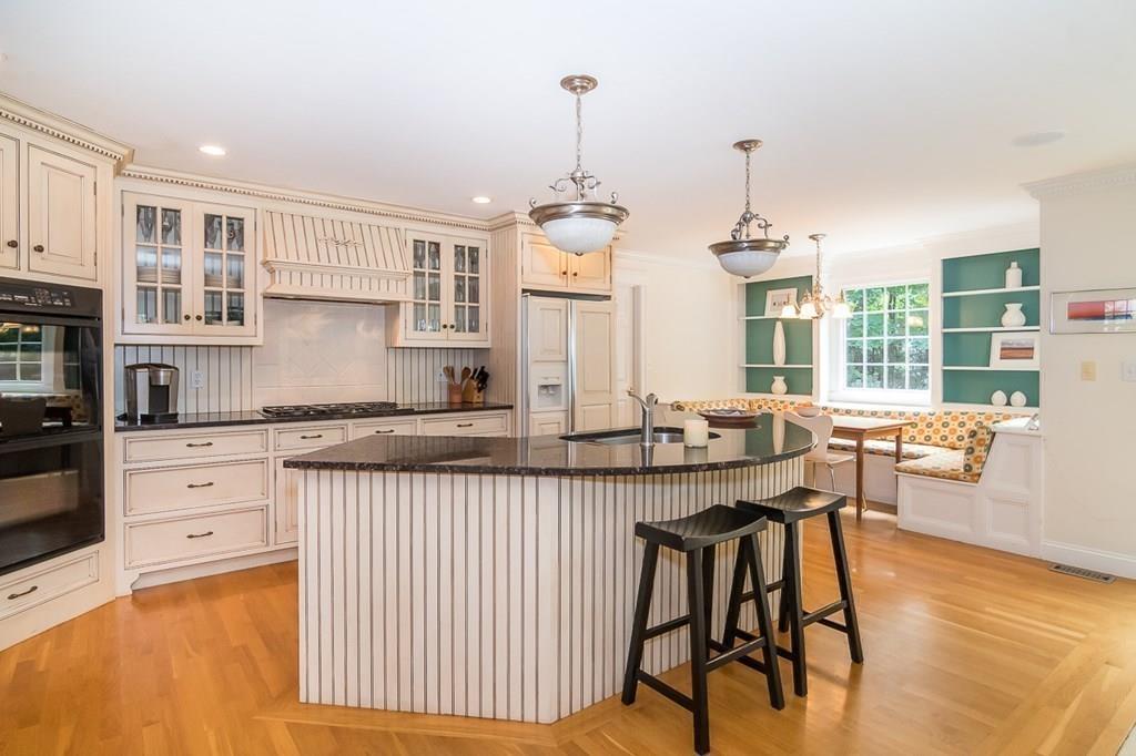 80 Mayo Road Wellesley, MA 02482 - Photo 3 of 22 a very nice looking kitchen with granite countertop a stove a sink a dining table and chairs