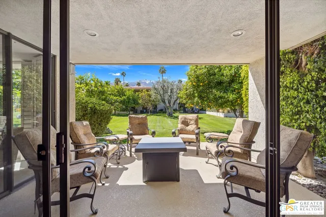 a view of a room with lounge chairs in patio