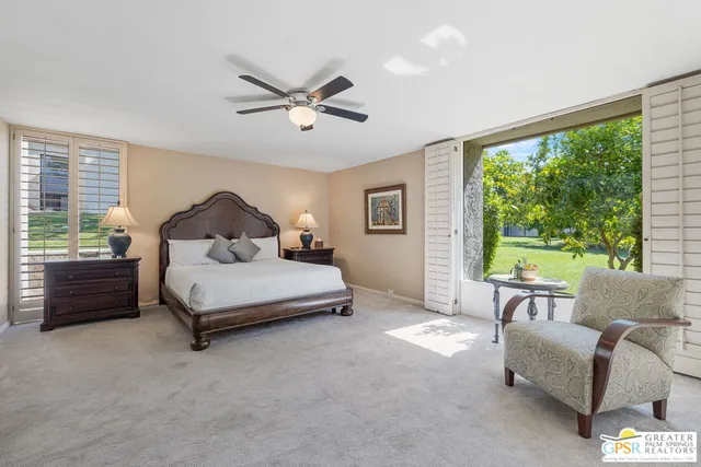 a bedroom with a bed couch and window