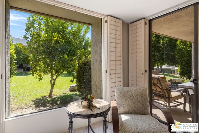 a view of a patio with table and chairs and potted plants