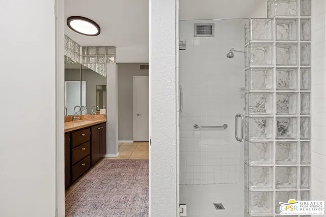 a bathroom with a double vanity sink and a mirror