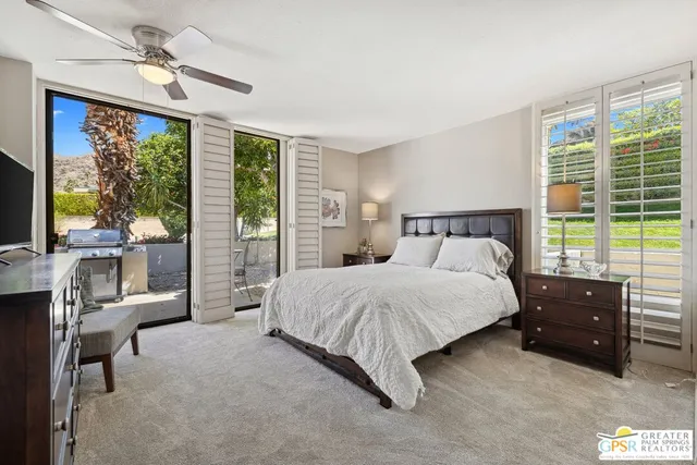 a spacious bedroom with a bed and a large window