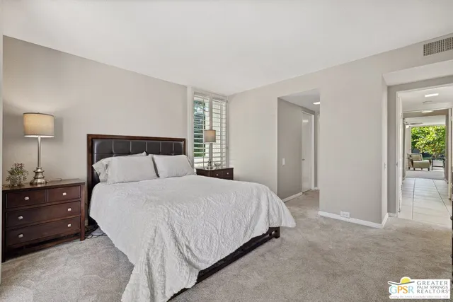 a bedroom with a bed and a lamp