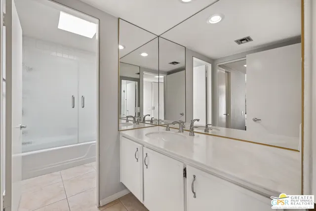 a bathroom with a granite countertop sink mirror and double