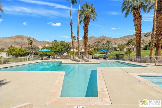 a view of a swimming pool with a yard