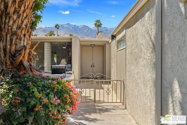 a view of a porch with a flower garden