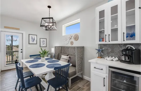 a kitchen with stainless steel appliances kitchen island a table and chairs in it