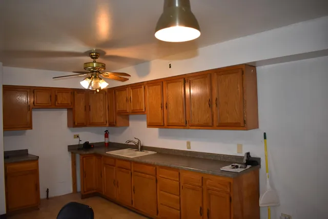a kitchen with a sink cabinets and window