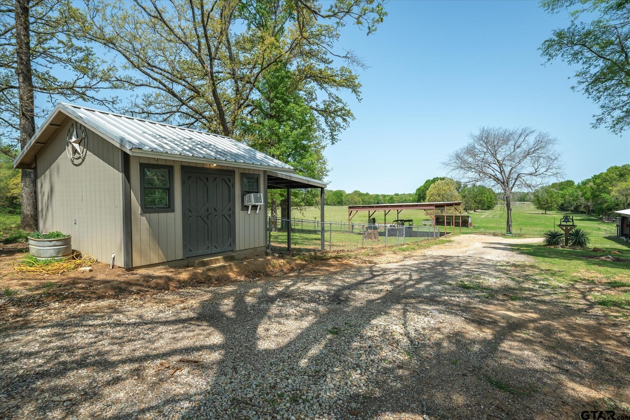 902 County Road 3710 Edgewood, TX 75117 - Photo 16 of 41 a view of a house with a yard and garage
