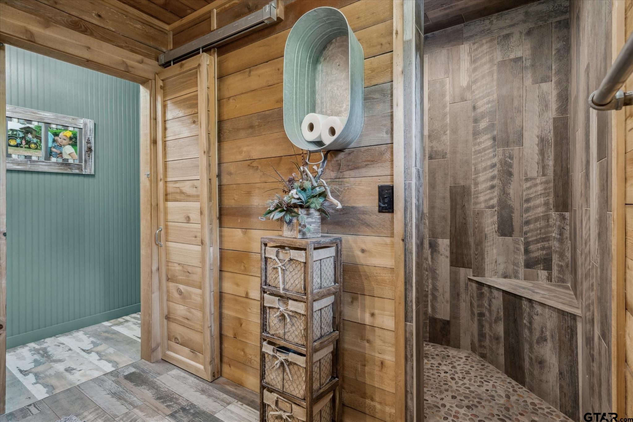 902 County Road 3710 Edgewood, TX 75117 - Photo 17 of 41 a vase of flowers sitting on a table in a bathroom