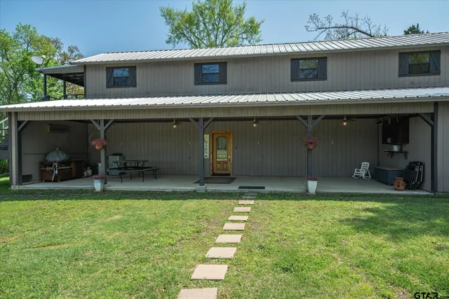 a view of a house with a yard and a garage