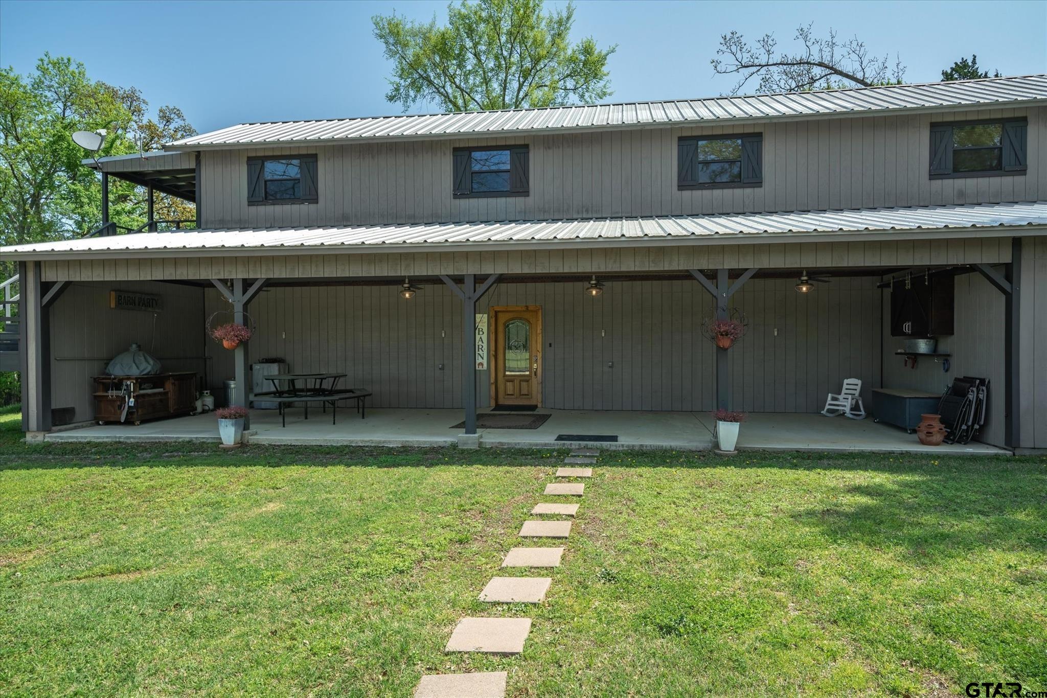 902 County Road 3710 Edgewood, TX 75117 - Photo 19 of 41 a view of a house with a yard and a garage