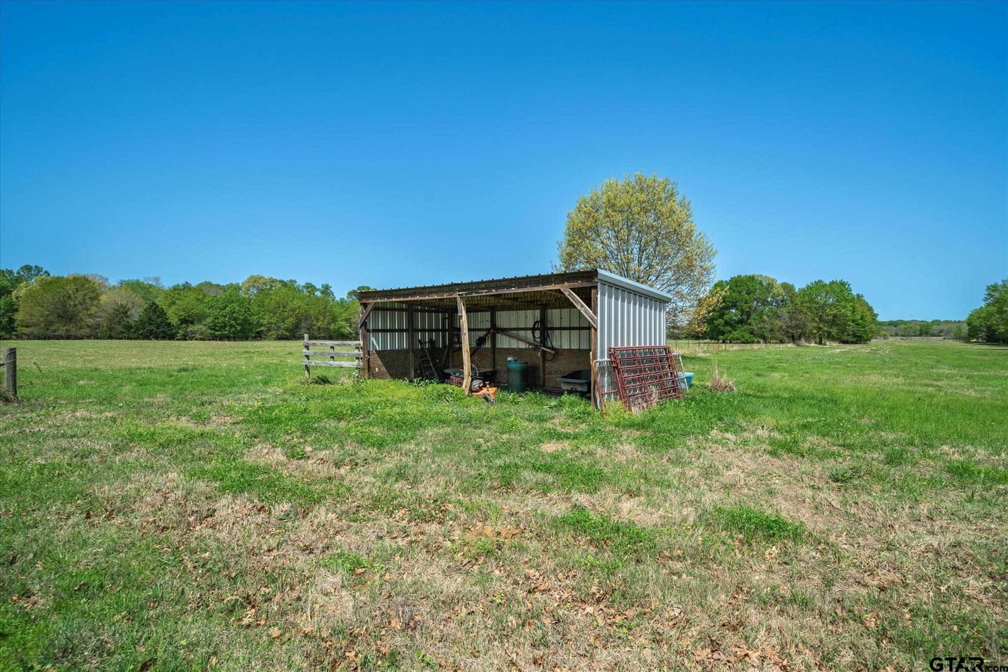 902 County Road 3710 Edgewood, TX 75117 - Photo 26 of 41 a backyard of a house with lots of green space and plants