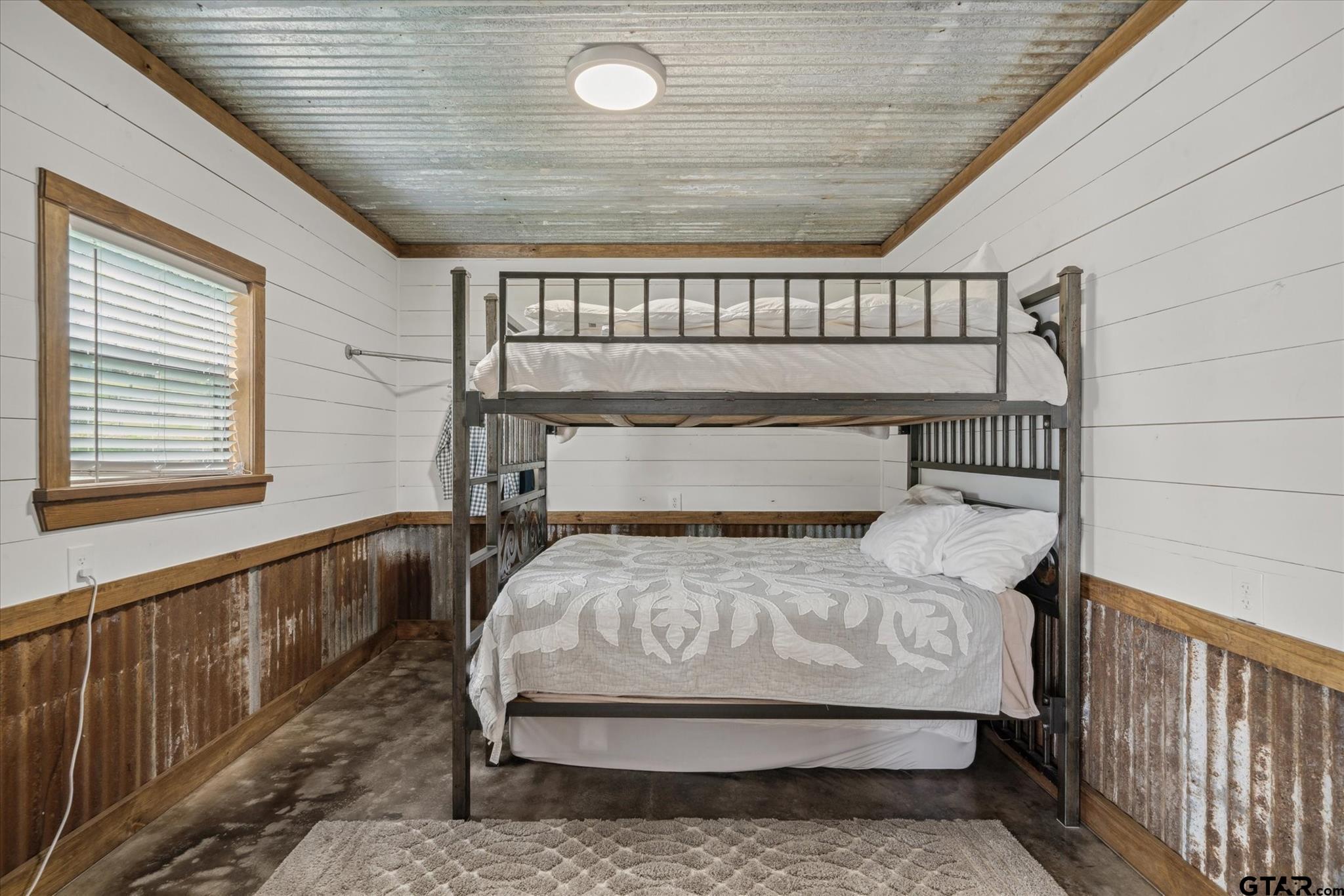 902 County Road 3710 Edgewood, TX 75117 - Photo 29 of 41 a bedroom with a bed and wooden floor