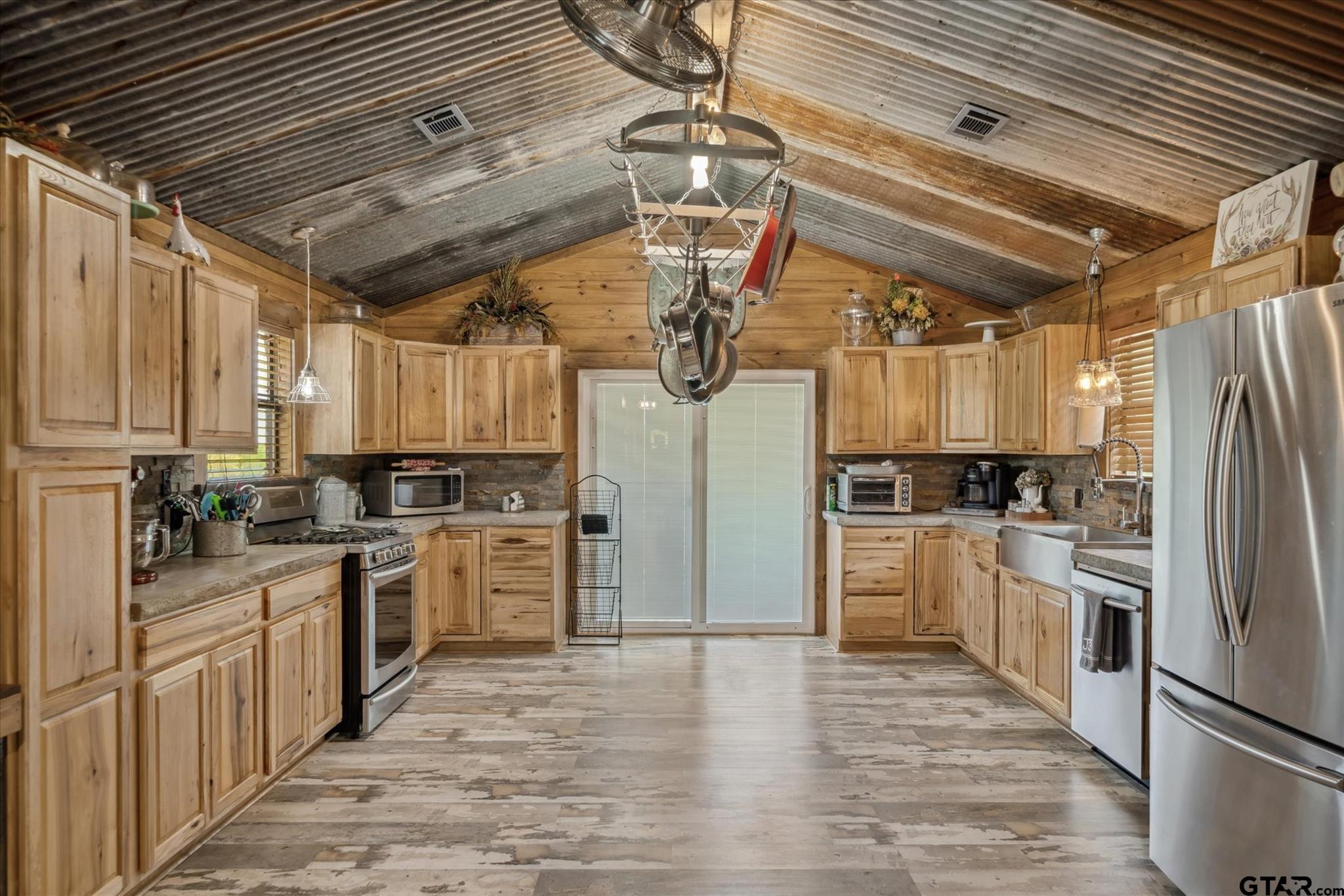 902 County Road 3710 Edgewood, TX 75117 - Photo 30 of 41 a kitchen with a refrigerator a stove top oven a sink and dishwasher