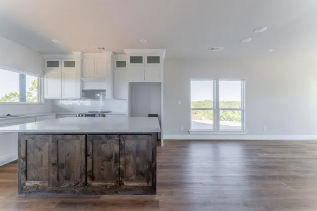a kitchen with stainless steel appliances granite countertop a sink and wooden cabinets