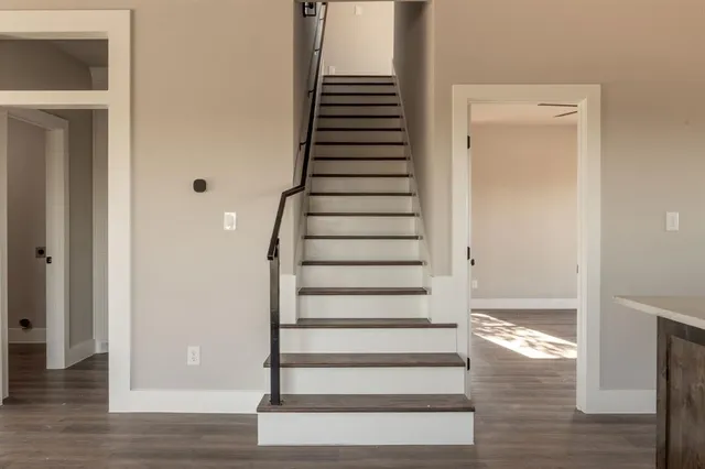 a view of entryway and hall with wooden floor