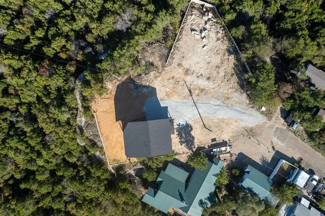 an aerial view of a house with a yard