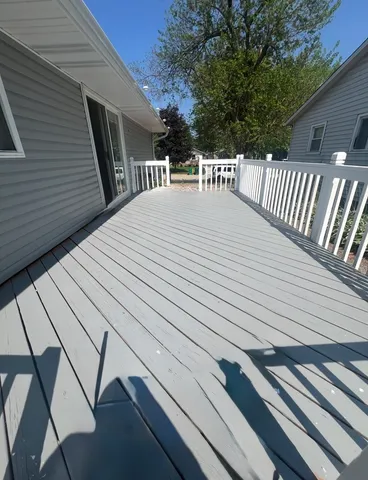 a view of a roof deck with wooden floor and fence
