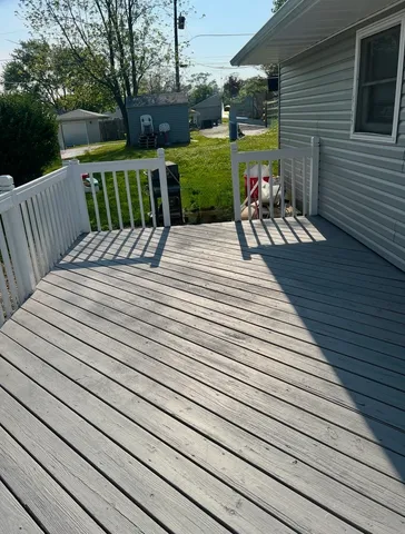 a view of a wooden deck with chairs