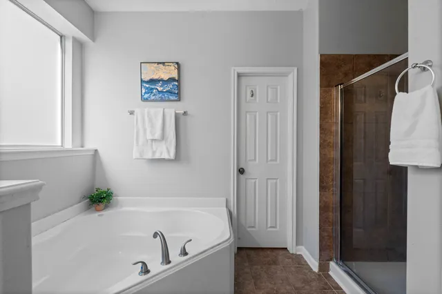 a bathroom with a tub and a shower
