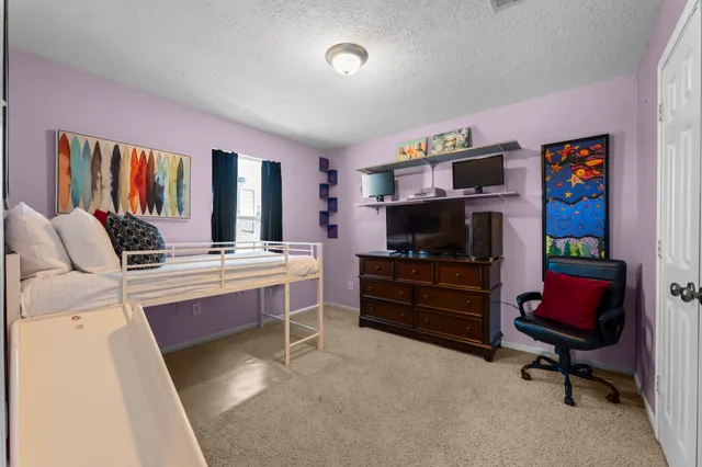 a room with furniture a piano and a flat screen tv