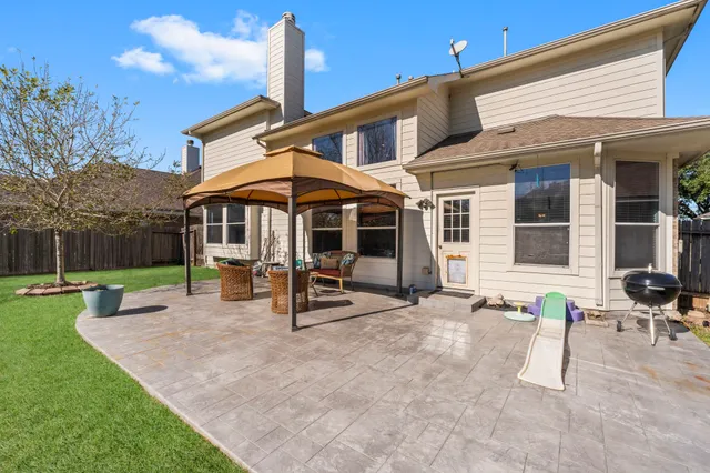 a view of a house with backyard porch and sitting area