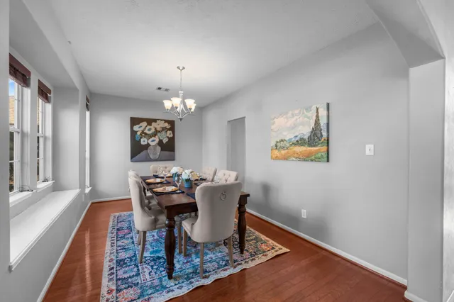 a dining room with furniture and window