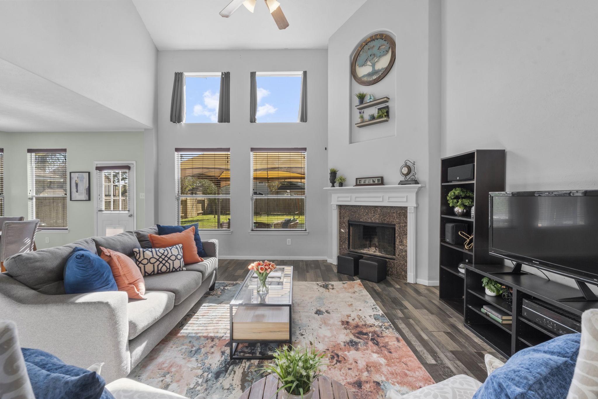 9011 Cedar Run Falls Tomball, TX 77375 - Photo 6 of 30 a living room with furniture a fireplace and a flat screen tv